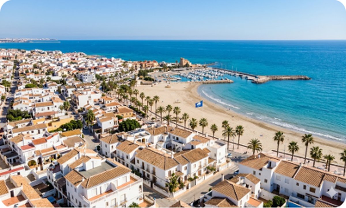 Aerial view of Torre de la Horadada coastline with marina and residential buildings